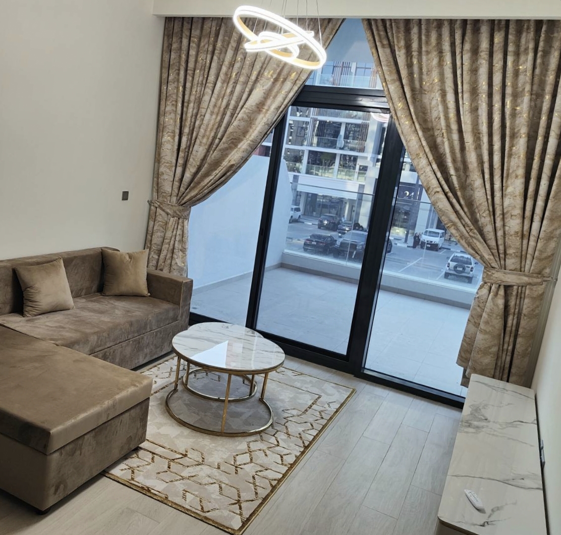 Luxury beige and gold velvet curtains in a Dubai apartment living room with tiebacks — installed by BCD